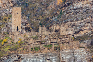 Fototapeta na wymiar Old stone town Kakhib, Dagestan, Russia. Ancient towers, ruins and houses on the rocks. Panoramic view of the city on the mountains