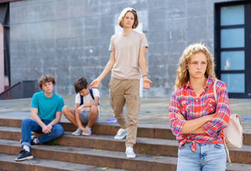 School friends in a quarrel, girl turned away from boys, a teenagers problems