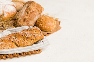Homemade natural breads. Different kinds of fresh bread as background, perspective view with copy space