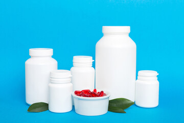 different drugs and health supplement pills with medicine bottle health care and medical top view. Vitamin tablets. Bottle with colored pills on table background. Multivitamins
