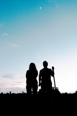 silhouette of a couple walking together in the twilight 