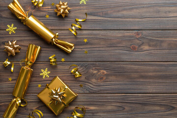 Christmas crackers with shiny confetti on color background, top view, copy space