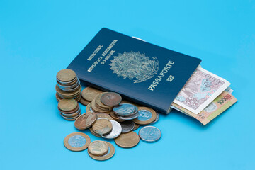 Passport with foreign money and a pile of real coins