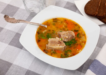 Portion of fresh russian soup rassolnik served on plate in eatery.