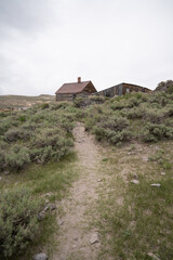 Antique Mining Town In Bodie State Historic Park. Vintage Buildings And Old Mining Equipment Still Standing In Good Condition.