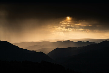 Fototapeta premium banner of mountain peaks in beautiful stormy sunset light