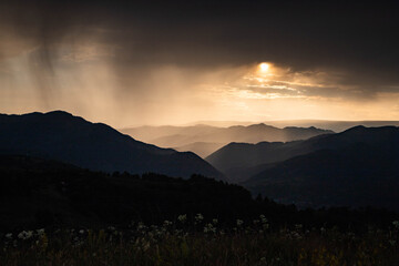 banner of mountain peaks in beautiful stormy sunset light