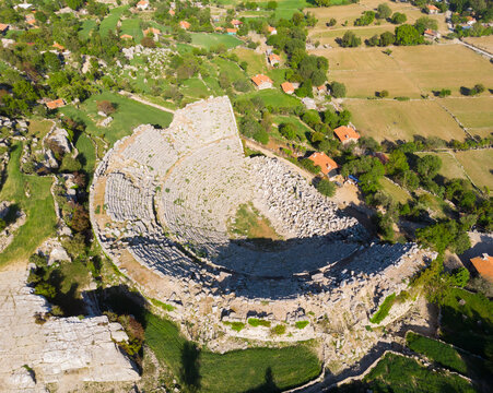 View from drone of ruins of Roman amphitheater at archaeological site of ancient city of Selge and picturesque surroundings on spring day, Altinkaya, Turkey