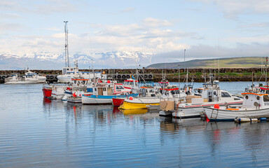 Harbors at Reykjavis, Iceland, with snowy mountains as background, under cloudy day
