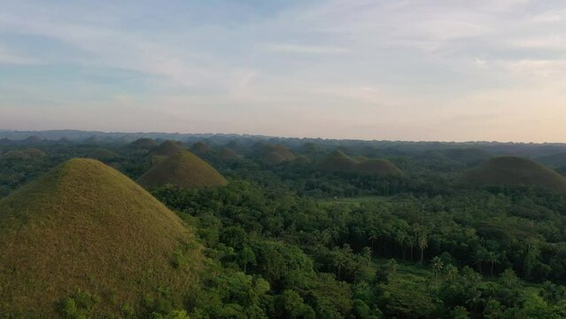 Slow motion aerial footage over the Chocolate Hills National Geological Monument in Carmen, Bohol province of the Philippines. With Copy space.