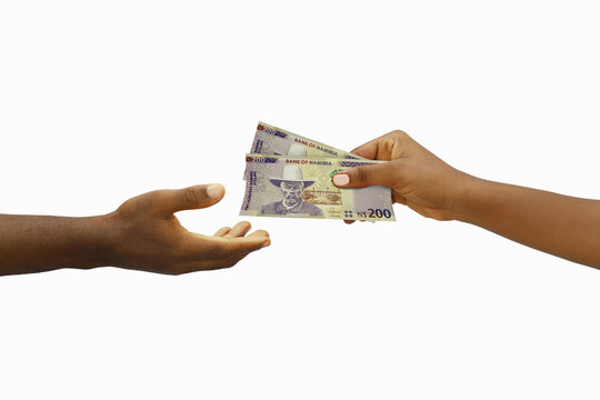 Hand giving 3D rendered 200 Namibian dollar notes to another hand. Hand receiving money