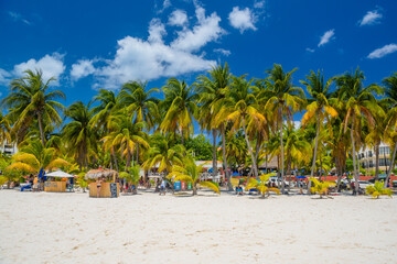 Cocos beach bar on a beach with white sand and palms on a sunny day, Isla Mujeres island, Caribbean...