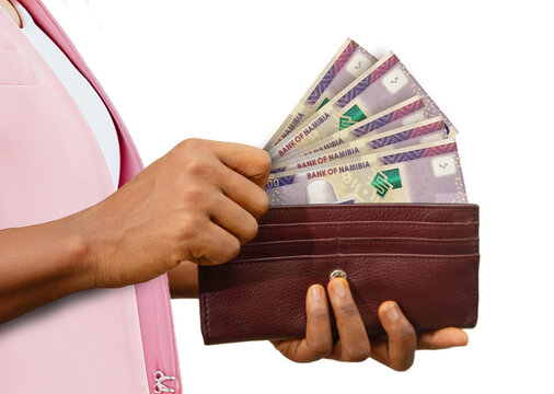 fair Female Hand Holding brown Purse With 200 Namibian dollar notes, hand removing money out of purse isolated on white. removing money from wallet