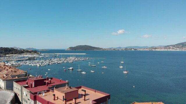 An aerial introduction to the Harbor of Baiona, Galicia, Spain.Baoina's Castle (Parador de Baiona) visible at the bottom.  A popular and highly visited European travel destination.