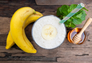 Banana fresh cocktail vanilla smoothies  fruit juice beverage healthy the taste yummy in glass drink episode good morning on wooden background from the top view.