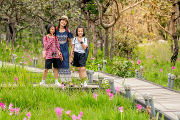 Fototapeta premium Children and parents travel and journey in forest of summer holiday season, lovely family people in beautiful nature
