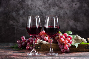 wine glass with red wine on wooden table