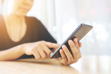 Close up image hand of woman using her mobile smartphone