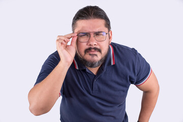 A middle aged man with eyeglasses squinting and leaning forward in an attempt to focus clearly at...