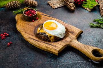 beef steak, beef patty with poached egg on the board