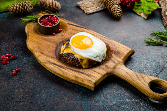 beef steak, beef patty with poached egg on the board - Powered by Adobe
