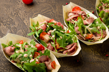 Salad with roast beef, tomatoes and aragula, canapes