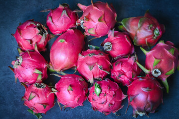 dragon fruit pitahaya on dark background , fresh dragon fruit tropical in the asian thailand healthy fruit concept - top view