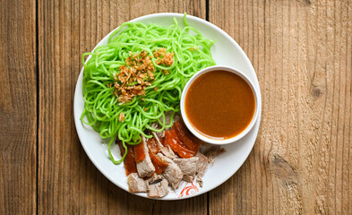 Jade noodle Asian Thailand food , roasted duck with jade noodle on white plate and duck sauce, green noodles Chinese food