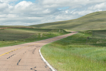 A winding road through the green hills of western Montana.