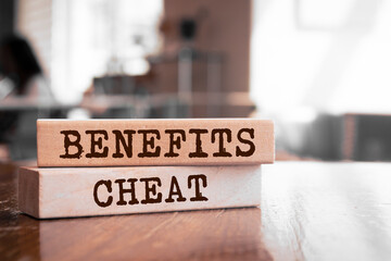 Wooden blocks with words 'BENEFITS CHEAT'.