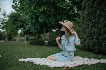 Romantic girl with hat on picnic in park