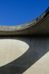Background image for design. The curved wall with the blue sky and shadows at Sante Park Tahara, Aichi, Japan. 