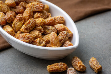 Indian dry dates in white bowl