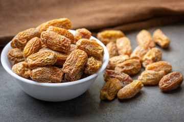 Indian dry dates in white bowl