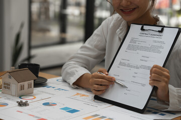 Real estate concept. Businessman pointing at agreement contract.