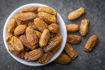 Indian dry dates in white bowl