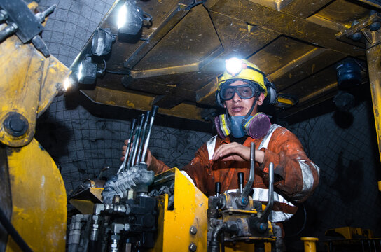 Miner operating a Jumbo Drill in an underground mine