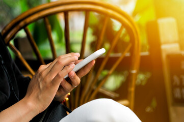 a chinese woman is playing internet mobile