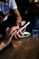 A Chinese women using smart phone for mobile payment and orders in the restaurant