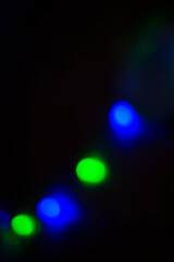 Blue and green circles on a black background. Round lights. Copy space for text.