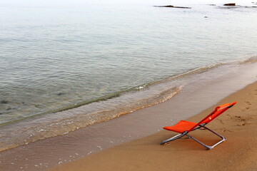 Fototapeta na wymiar Chair on the Mediterranean Sea