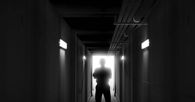 Image of man silhouette standing in dark corridor