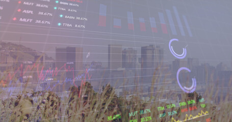 Image of financial graph and data processing over cityscape