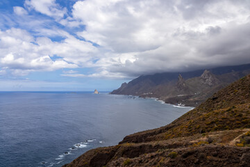 Fototapeta na wymiar Scenic view of Atlantic Ocean coastline and Anaga mountain range on Tenerife, Canary Islands, Spain, Europe. Looking at Roque de las Animas crag and Roque en Medio. Hiking trail from Afur to Taganana