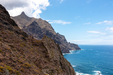 Panoramic view of Atlantic Ocean coastline and Anaga mountain range on Tenerife, Canary Islands, Spain, Europe, EU. Looking at Cabezo el Tablero crag. Scenic coastal hiking trail from Afur to Taganana