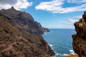 Panoramic view of Atlantic Ocean coastline and Anaga mountain range on Tenerife, Canary Islands, Spain, Europe, EU. Looking at Cabezo el Tablero crag. Scenic coastal hiking trail from Afur to Taganana