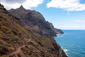 Fototapeta premium Panoramic view of Atlantic Ocean coastline and Anaga mountain range on Tenerife, Canary Islands, Spain, Europe, EU. Looking at Cabezo el Tablero crag. Scenic coastal hiking trail from Afur to Taganana