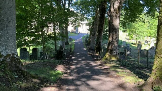 Tree lined pathway leading to St Andrew's medieval church, Aysgarth in the Yorkshire Dales National Park