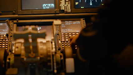 Male copilot inserting flight coordinates to arrive at destination, using dashboard command for...