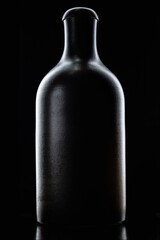 
black bottle on black background low key
